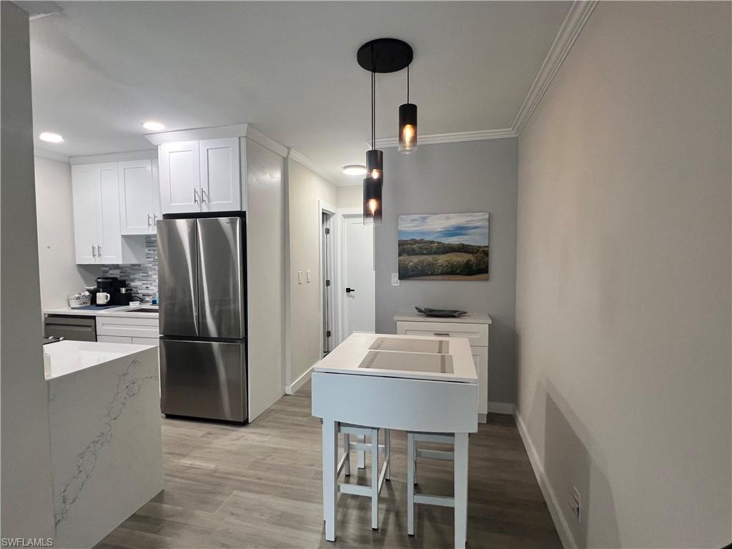473 12th Avenue South, Unit B6 Naples, FL 34102 - Photo 9 of 10 a kitchen with refrigerator and microwave