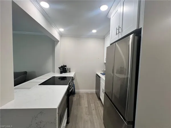 a kitchen with a sink and refrigerator