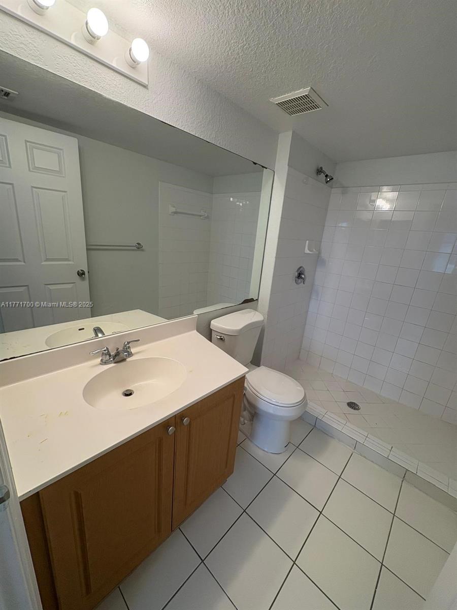 15422 Southwest 284th Street, Unit 7302 Homestead, FL 33033 - Photo 21 of 44 a bathroom with a sink a toilet and shower