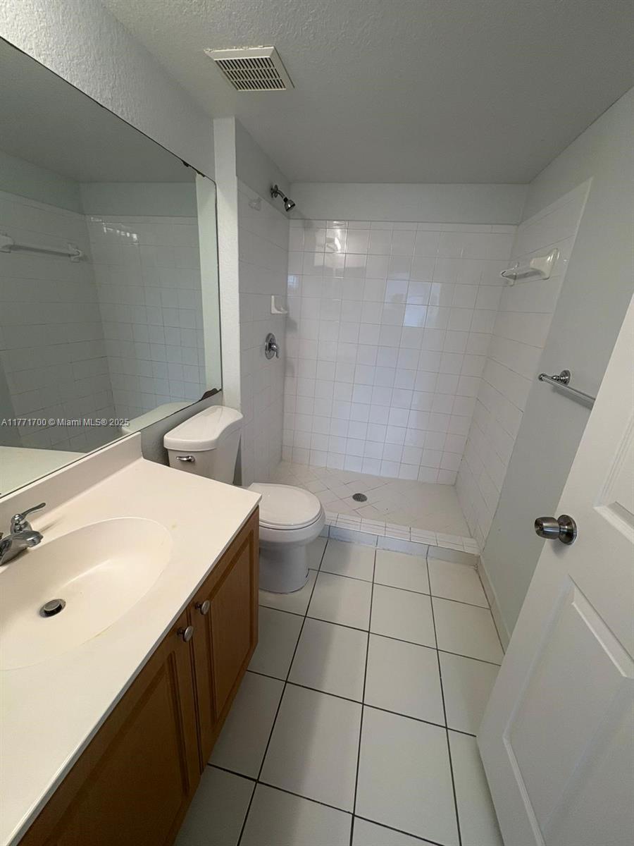15422 Southwest 284th Street, Unit 7302 Homestead, FL 33033 - Photo 22 of 44 a bathroom with a sink a toilet and shower