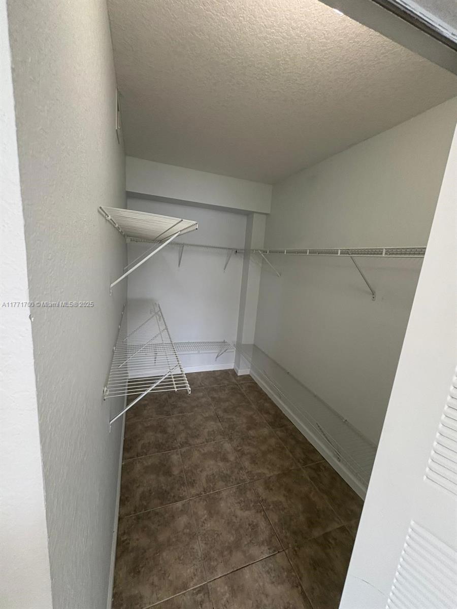 15422 Southwest 284th Street, Unit 7302 Homestead, FL 33033 - Photo 23 of 44 a view of a room with racks on the wall