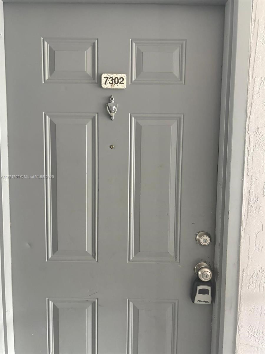 15422 Southwest 284th Street, Unit 7302 Homestead, FL 33033 - Photo 26 of 44 a view of a hallway with a window