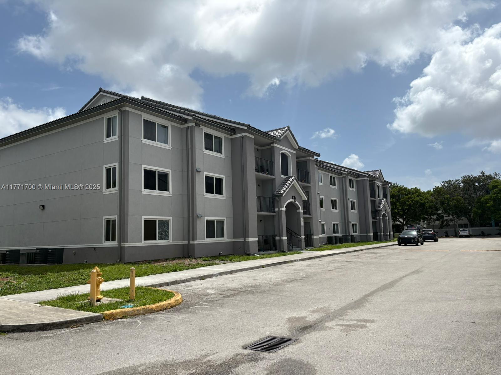 15422 Southwest 284th Street, Unit 7302 Homestead, FL 33033 - Photo 29 of 44 a front view of a building with a garden
