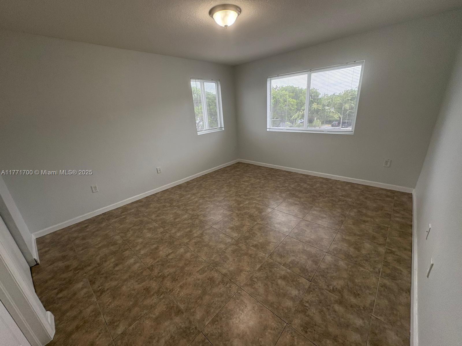 15422 Southwest 284th Street, Unit 7302 Homestead, FL 33033 - Photo 3 of 44 an empty room with windows