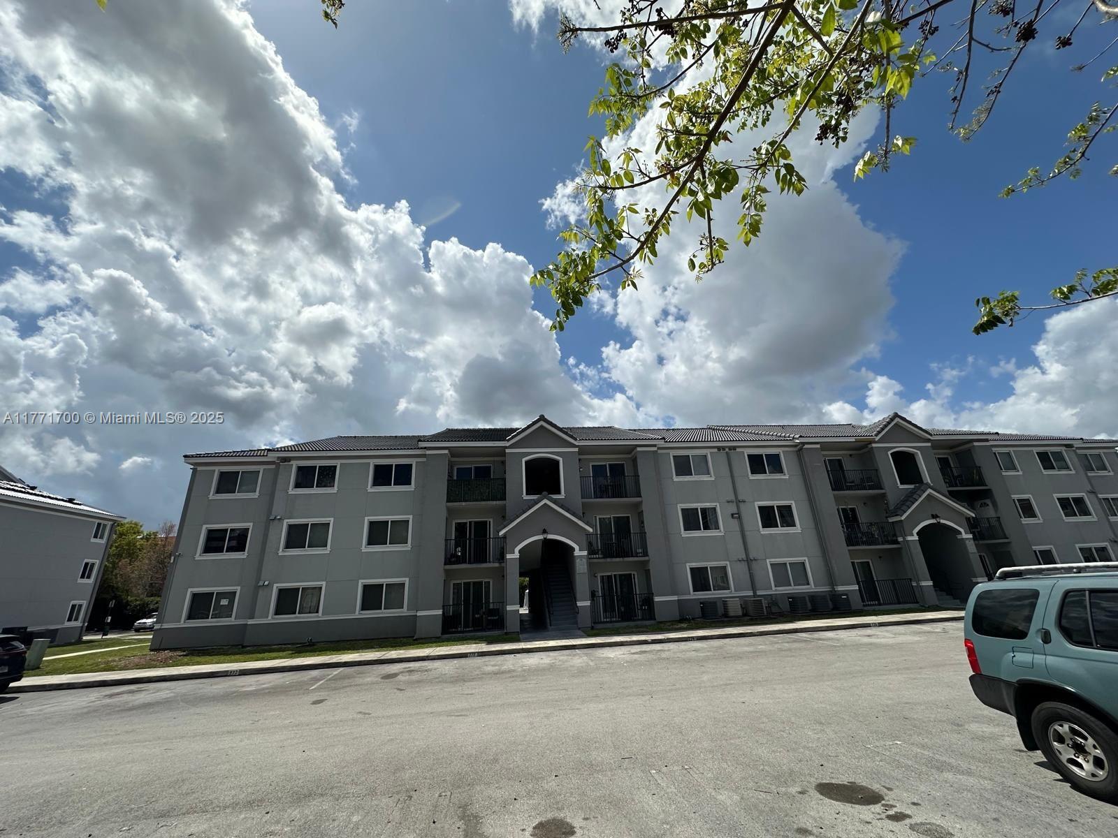 15422 Southwest 284th Street, Unit 7302 Homestead, FL 33033 - Photo 32 of 44 a front view of building with parking space