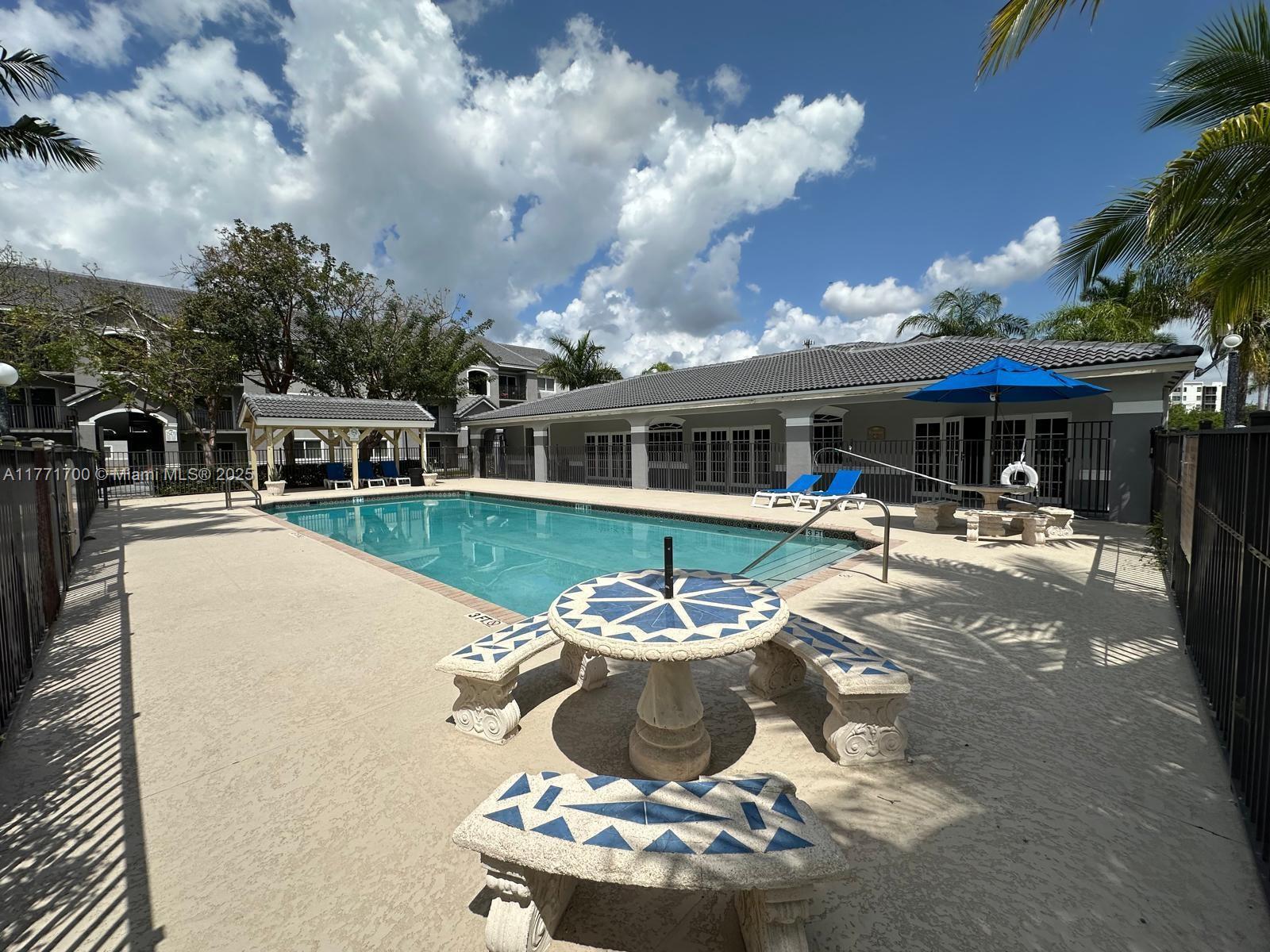 15422 Southwest 284th Street, Unit 7302 Homestead, FL 33033 - Photo 41 of 44 a view of a house with swimming pool and sitting area