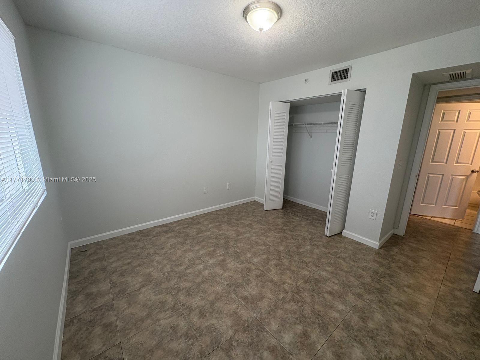15422 Southwest 284th Street, Unit 7302 Homestead, FL 33033 - Photo 6 of 44 an empty room with windows