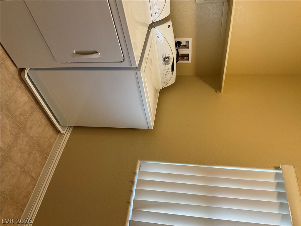 12 Jasmine Point Street Henderson, NV 89074 - Photo 12 of 15 A dedicated laundry space provides optimal functionality with stacked appliances and tiled flooring.