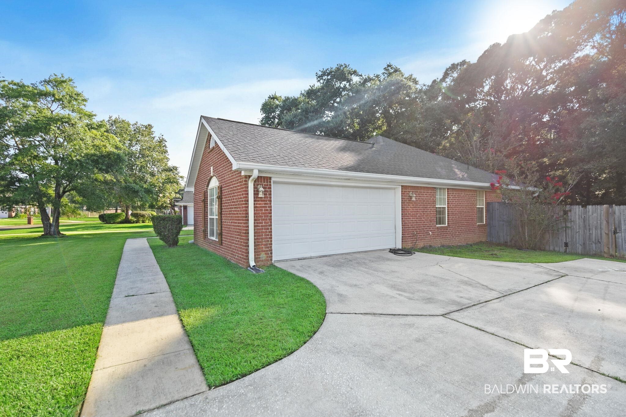10550 Patrick Avenue Grand Bay, AL 36541 - Photo 6 of 43 View of property exterior featuring a garage and a lawn