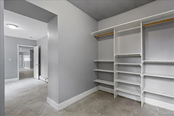 a view of an empty room with a closet