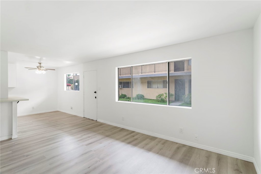 5535 Ackerfield Avenue, Unit 8 Long Beach, CA 90805 - Photo 13 of 31 an empty room with wooden floor and windows