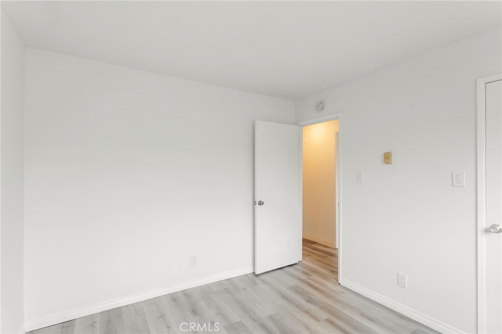 5535 Ackerfield Avenue, Unit 8 Long Beach, CA 90805 - Photo 17 of 31 a view of an empty room with wooden floor
