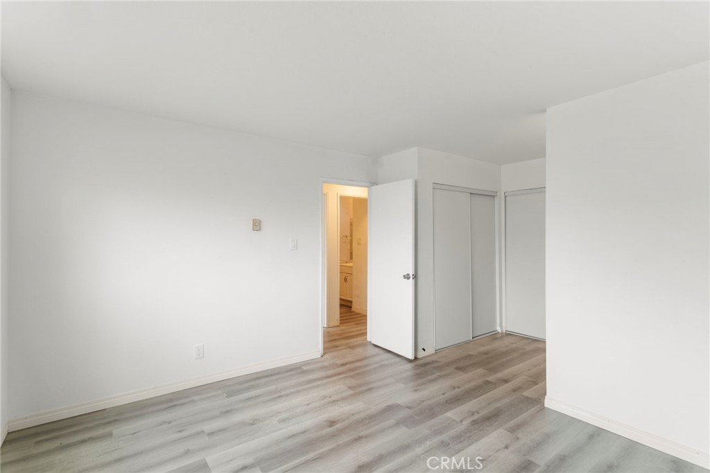 5535 Ackerfield Avenue, Unit 8 Long Beach, CA 90805 - Photo 20 of 31 a view of an empty room and wooden floor