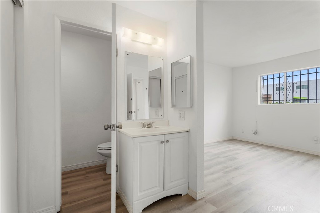 5535 Ackerfield Avenue, Unit 8 Long Beach, CA 90805 - Photo 23 of 31 a bathroom with a sink a toilet and shower