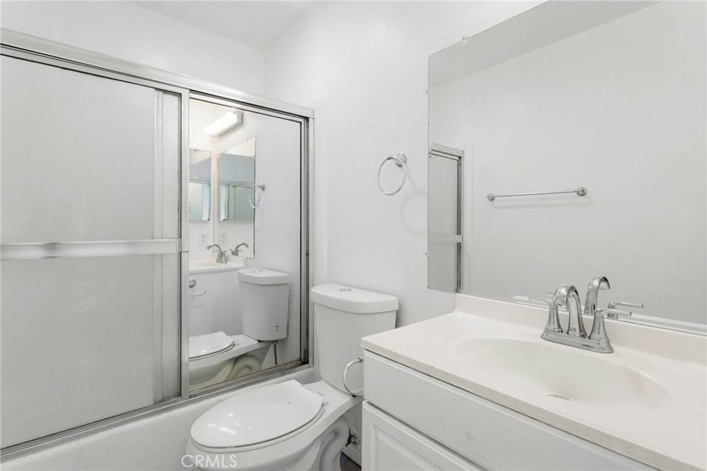 5535 Ackerfield Avenue, Unit 8 Long Beach, CA 90805 - Photo 24 of 31 a bathroom with a sink a toilet and shower