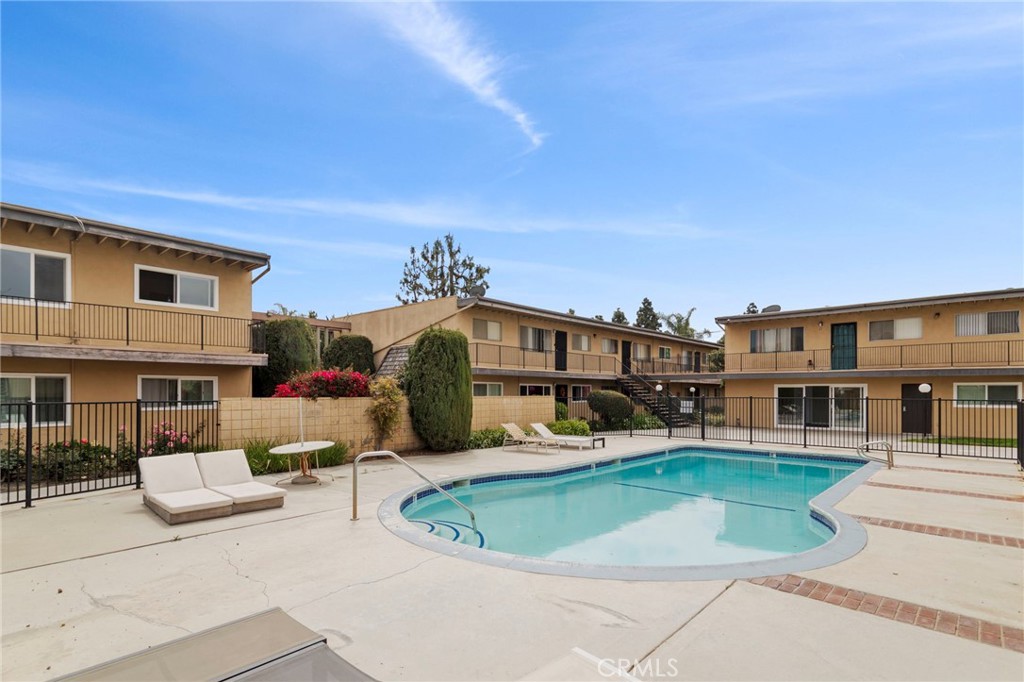 5535 Ackerfield Avenue, Unit 8 Long Beach, CA 90805 - Photo 28 of 31 a front view of a house with a yard table and chairs