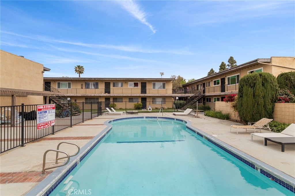 5535 Ackerfield Avenue, Unit 8 Long Beach, CA 90805 - Photo 29 of 31 a view of a swimming pool with a lounge chair