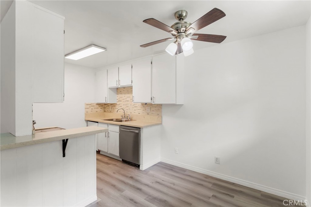 5535 Ackerfield Avenue, Unit 8 Long Beach, CA 90805 - Photo 7 of 31 a kitchen with a white cabinets and white appliances