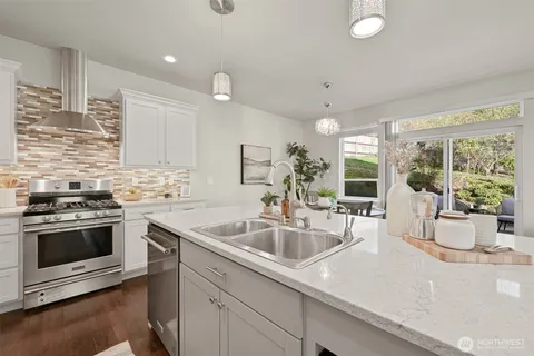 a kitchen with a sink and stove top oven