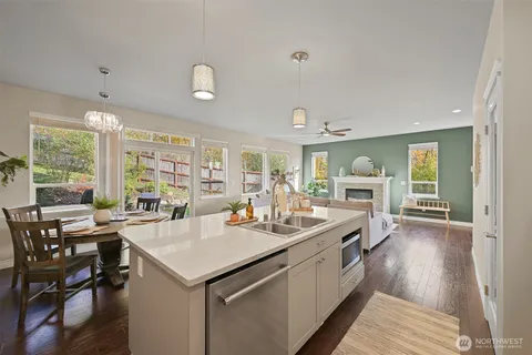 a view of a open kitchen with a sink and cabinets