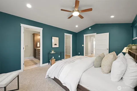 a bedroom with a large bed and a chandelier