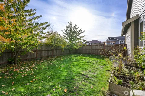 an aerial view of a house with a yard and potted plants