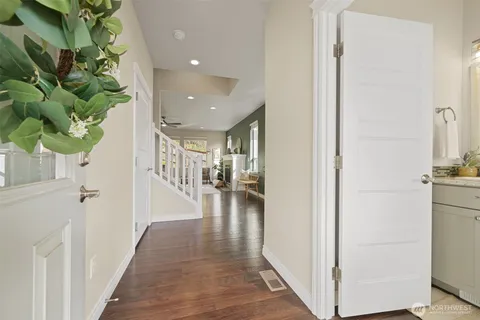 a hallway with wooden floor and entryway