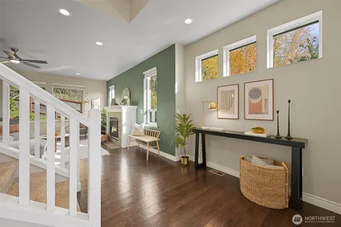 a hallway with couches and wooden floor