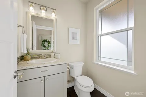 a bathroom with a sink toilet vanity and mirror