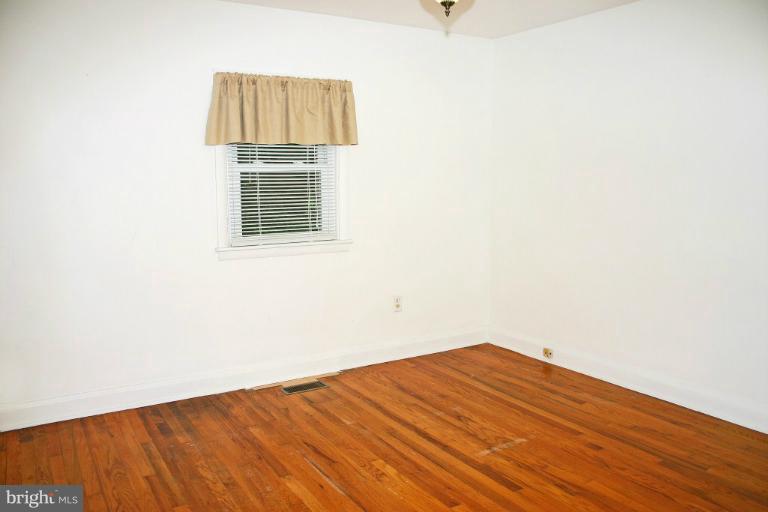 4835 Maple Grove Road Hampstead, MD 21074 - Photo 12 of 27 a view of empty room with wooden floor and fan