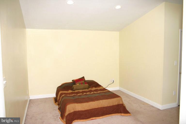 4835 Maple Grove Road Hampstead, MD 21074 - Photo 15 of 27 a bedroom with a bed and a cabinets