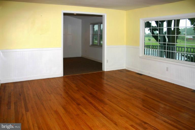 4835 Maple Grove Road Hampstead, MD 21074 - Photo 17 of 27 a view of an empty room with wooden floor and a window