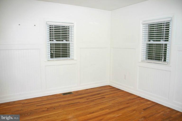 4835 Maple Grove Road Hampstead, MD 21074 - Photo 18 of 27 a view of empty room with wooden floor and fan