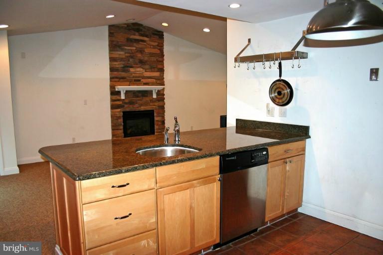 4835 Maple Grove Road Hampstead, MD 21074 - Photo 19 of 27 a kitchen with stainless steel appliances granite countertop a stove a sink and a refrigerator
