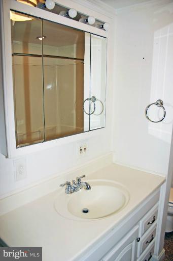 4835 Maple Grove Road Hampstead, MD 21074 - Photo 3 of 27 a bathroom with a sink and a mirror