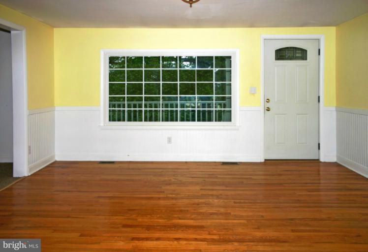 4835 Maple Grove Road Hampstead, MD 21074 - Photo 5 of 27 a view of an empty room with wooden floor and a window