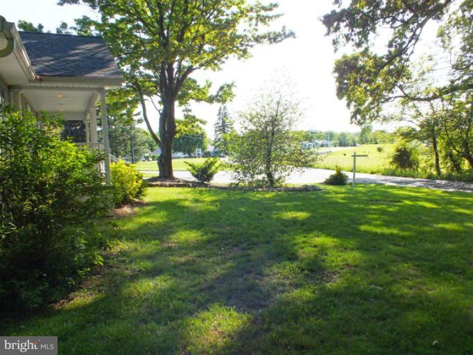 4835 Maple Grove Road Hampstead, MD 21074 - Photo 8 of 27 a view of a garden with plants and large trees