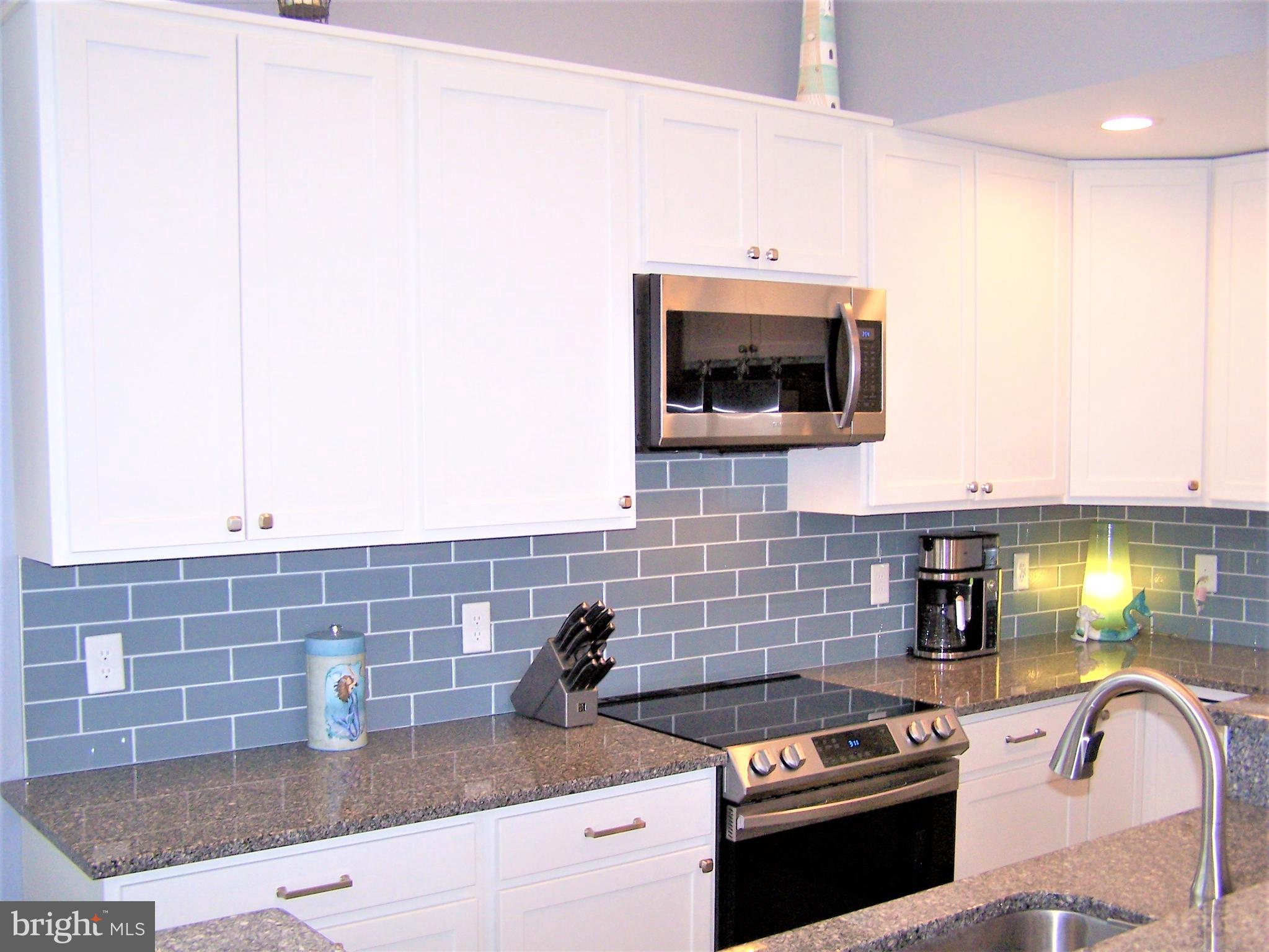 199 Clamshell Road Ocean City, MD 21842 - Photo 21 of 65 Granite Counters with Glass Tile Backsplash