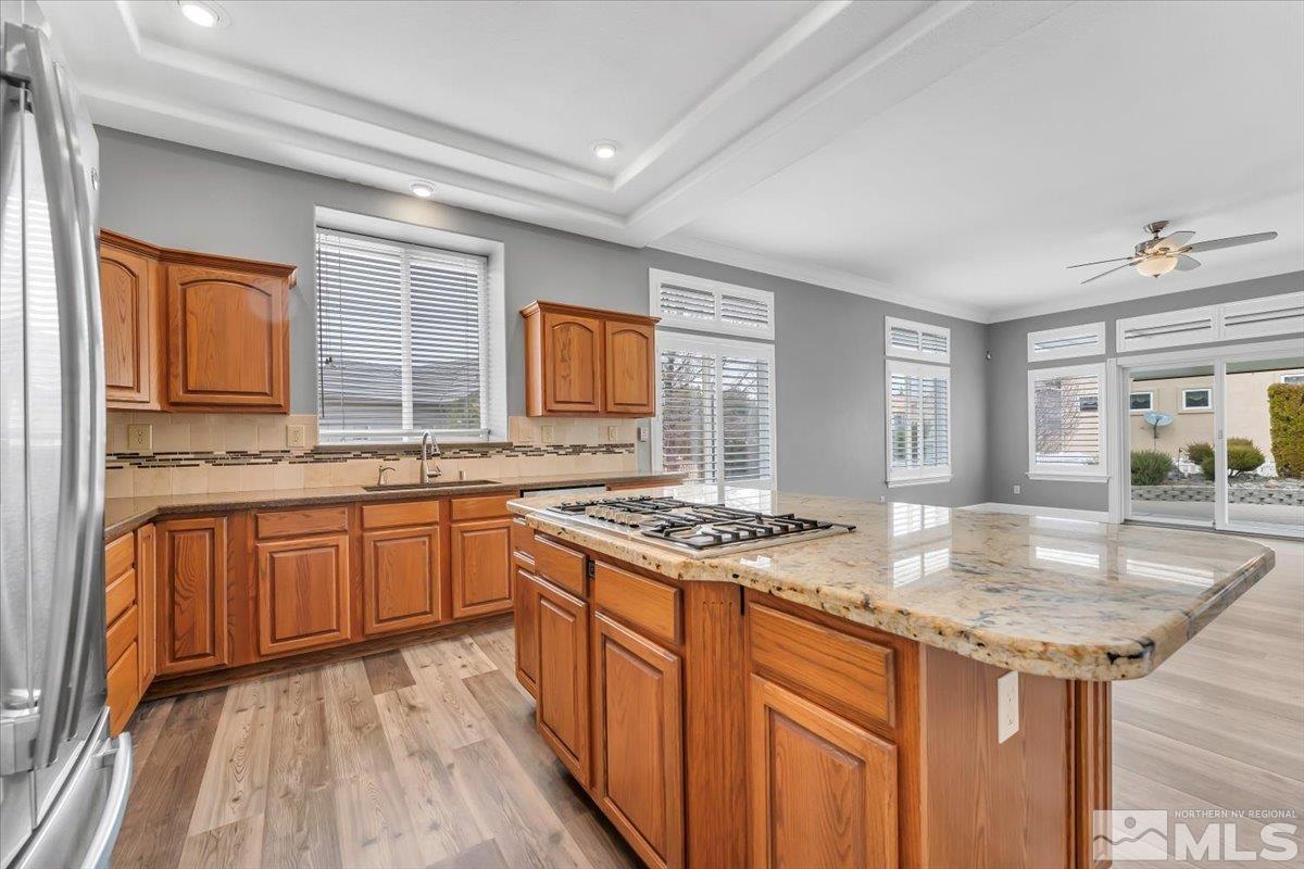 1900 Hidden Meadows Drive Reno, NV 89502 - Photo 14 of 37 a kitchen with granite countertop a sink stove and cabinets