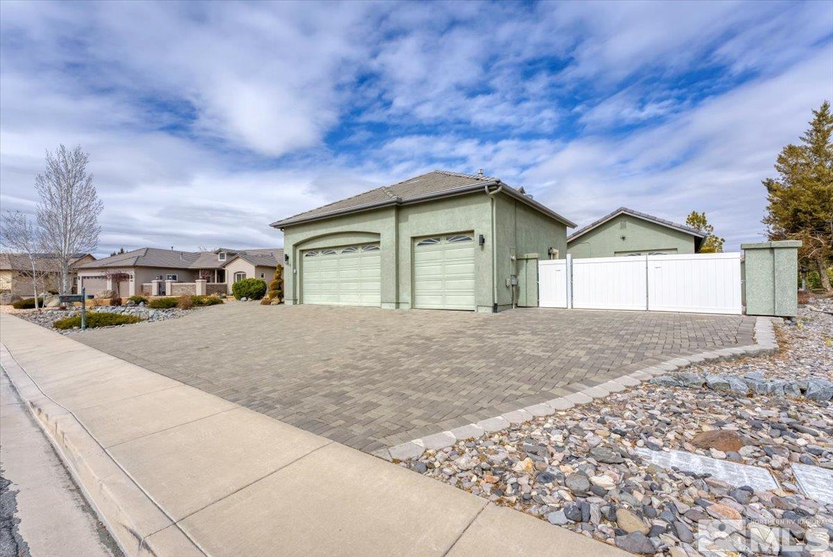 1900 Hidden Meadows Drive Reno, NV 89502 - Photo 2 of 37 a view of garage with yard and car parked