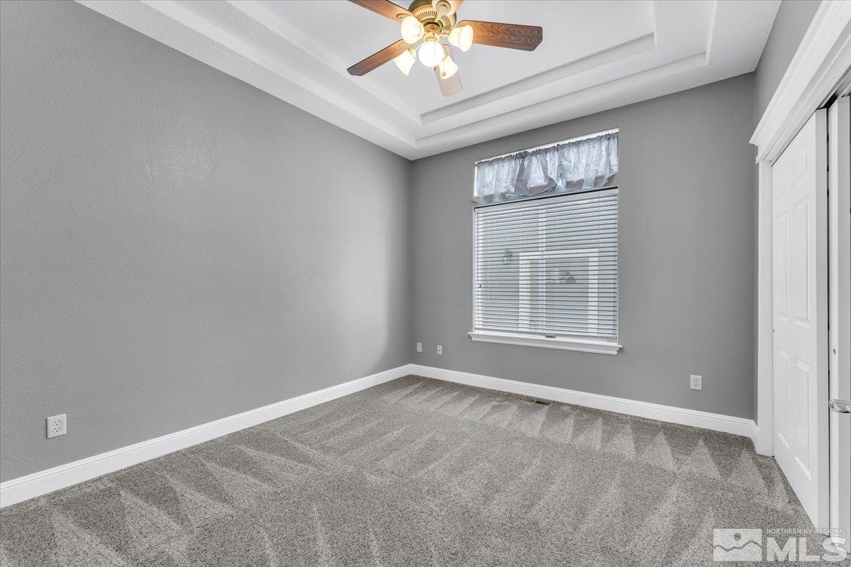 1900 Hidden Meadows Drive Reno, NV 89502 - Photo 21 of 37 en empty room with windows and ceiling fan
