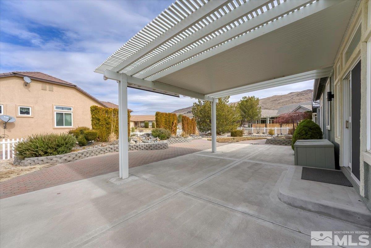 1900 Hidden Meadows Drive Reno, NV 89502 - Photo 27 of 37 a view of a patio with a table and chairs next to a road