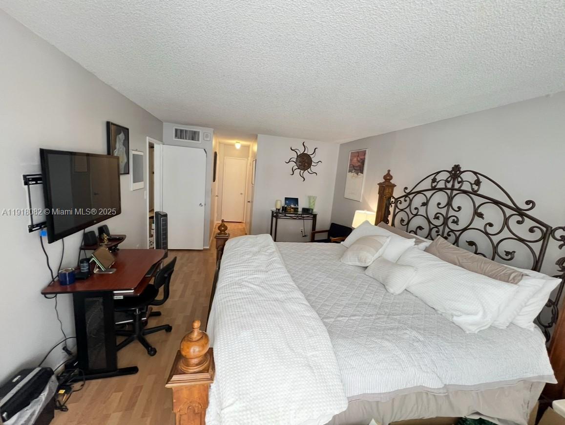 1228 West Avenue, Unit 911 Miami Beach, FL 33139 - Photo 15 of 24 a bedroom with a bed and a flat screen tv