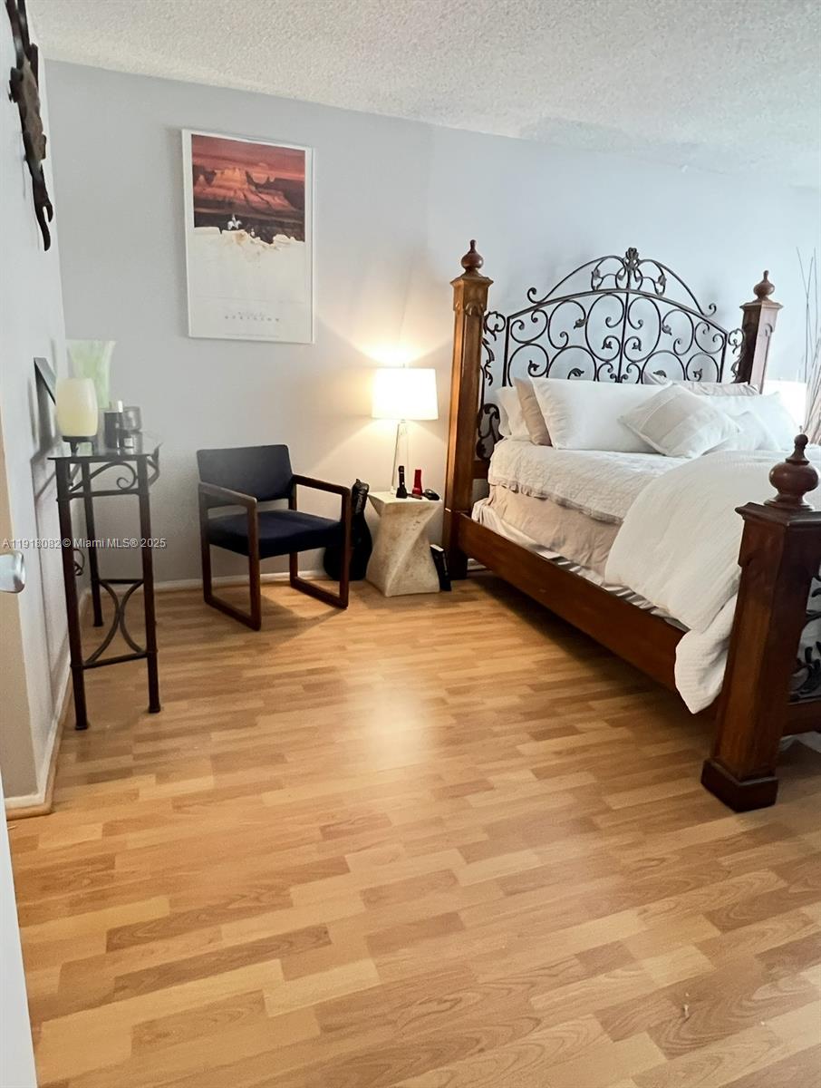 1228 West Avenue, Unit 911 Miami Beach, FL 33139 - Photo 17 of 24 a bedroom with a bed and a table in it