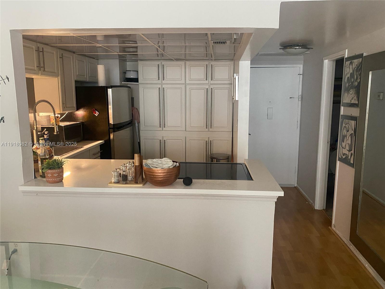 1228 West Avenue, Unit 911 Miami Beach, FL 33139 - Photo 2 of 24 a bathroom with a sink and a mirror