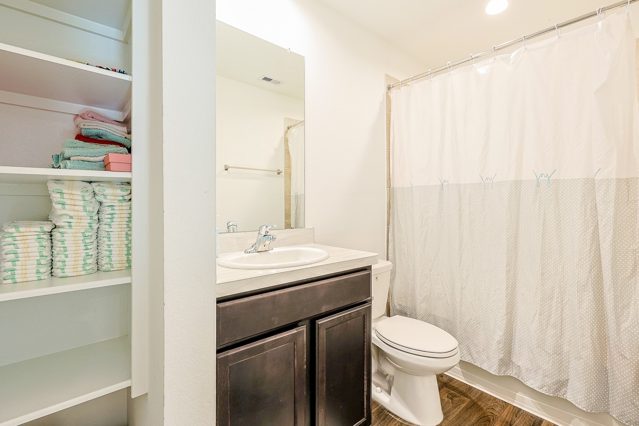 22603 Aspen Tarn Trail Spring, TX 77373 - Photo 16 of 20 a bathroom with a sink a toilet and a mirror