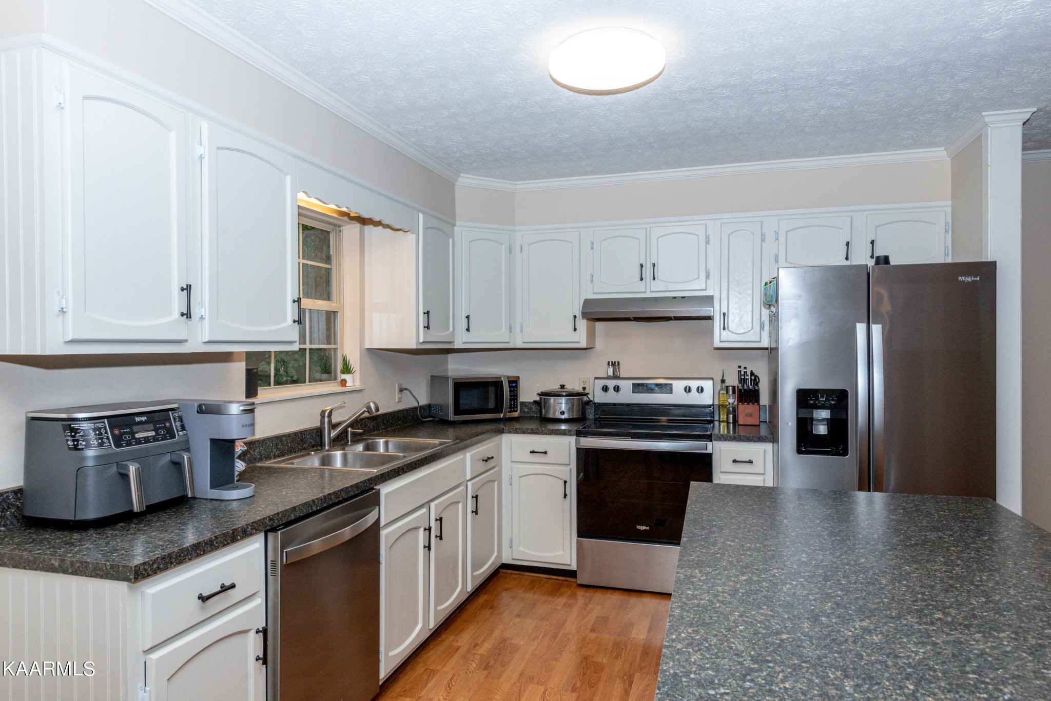 125 Lakeview Estates Road Vonore, TN 37885 - Photo 11 of 46 a kitchen with stainless steel appliances granite countertop a stove a sink dishwasher and a refrigerator
