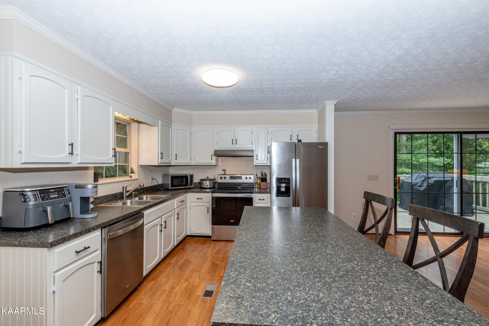 125 Lakeview Estates Road Vonore, TN 37885 - Photo 12 of 46 a kitchen with stainless steel appliances granite countertop a stove refrigerator sink and cabinets