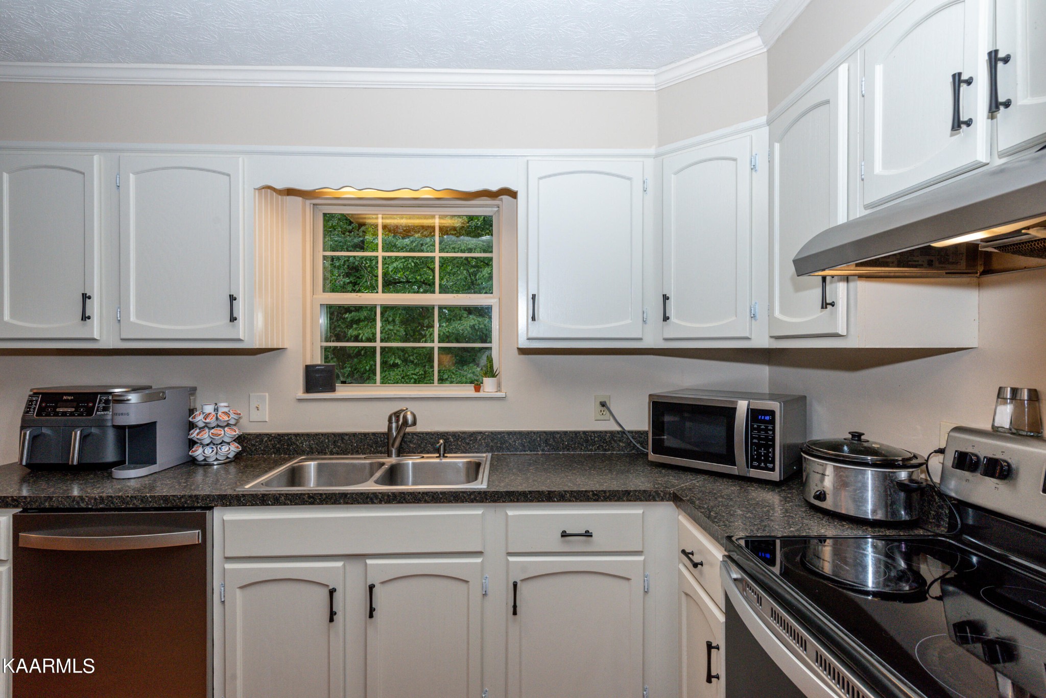 125 Lakeview Estates Road Vonore, TN 37885 - Photo 13 of 46 a kitchen with stainless steel appliances granite countertop white cabinets stove and a sink