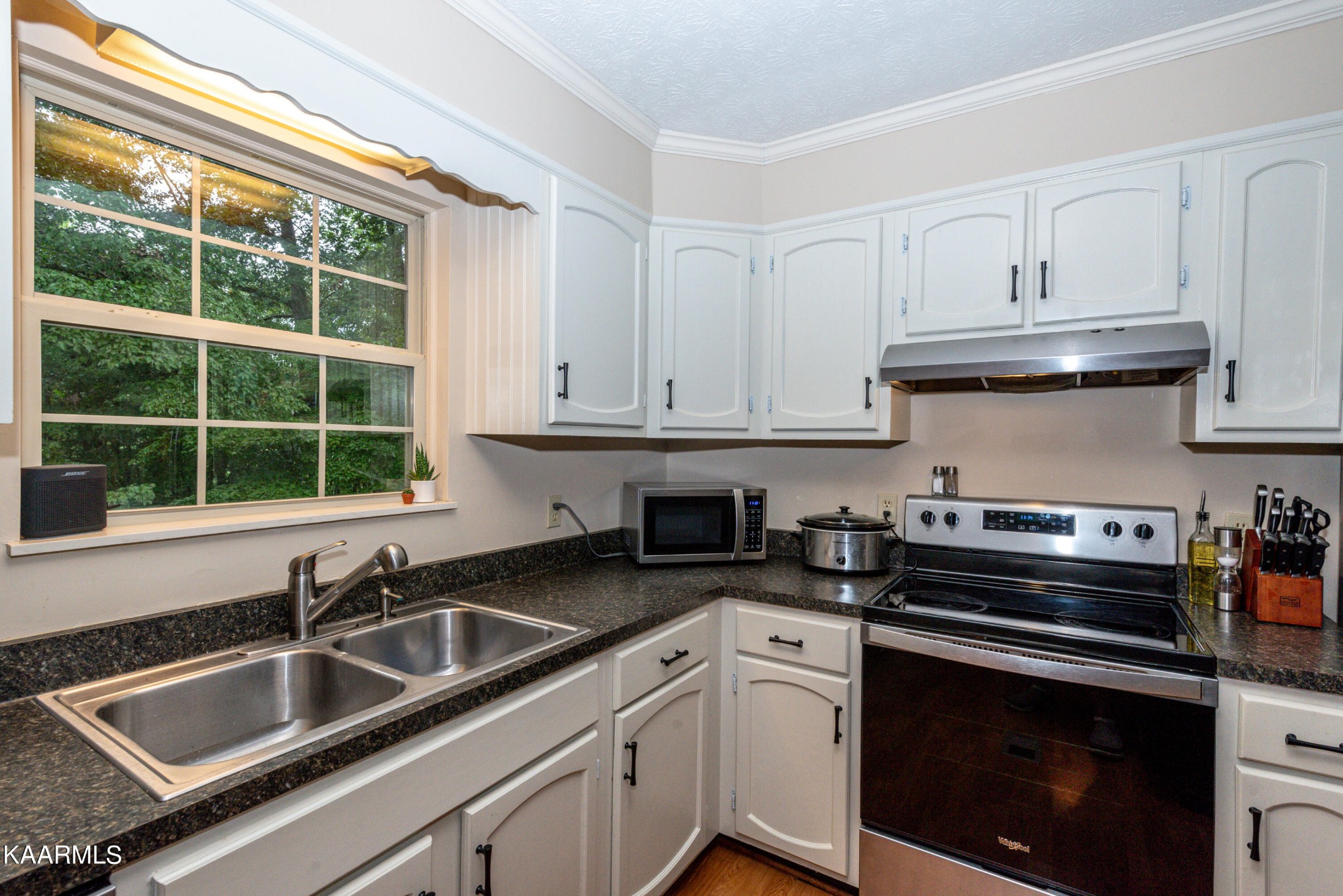 125 Lakeview Estates Road Vonore, TN 37885 - Photo 14 of 46 a kitchen with granite countertop a sink stove top oven and cabinets